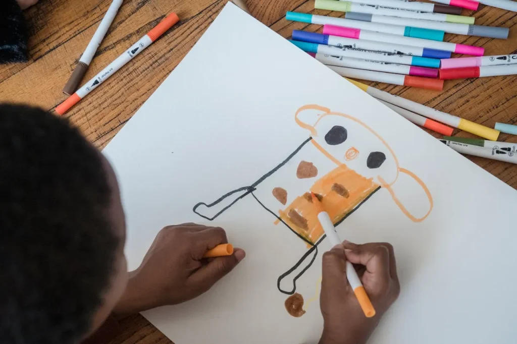 Child drawing a picture to remember a beloved pet after loss.