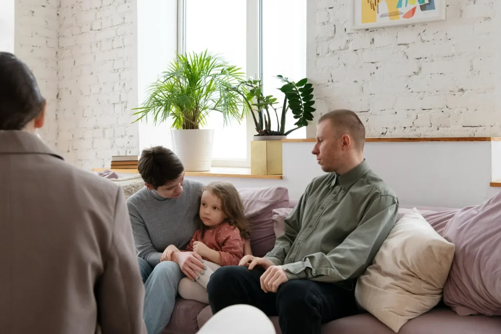 Parent gently comforting a child while talking about the loss of a family pet at home.
