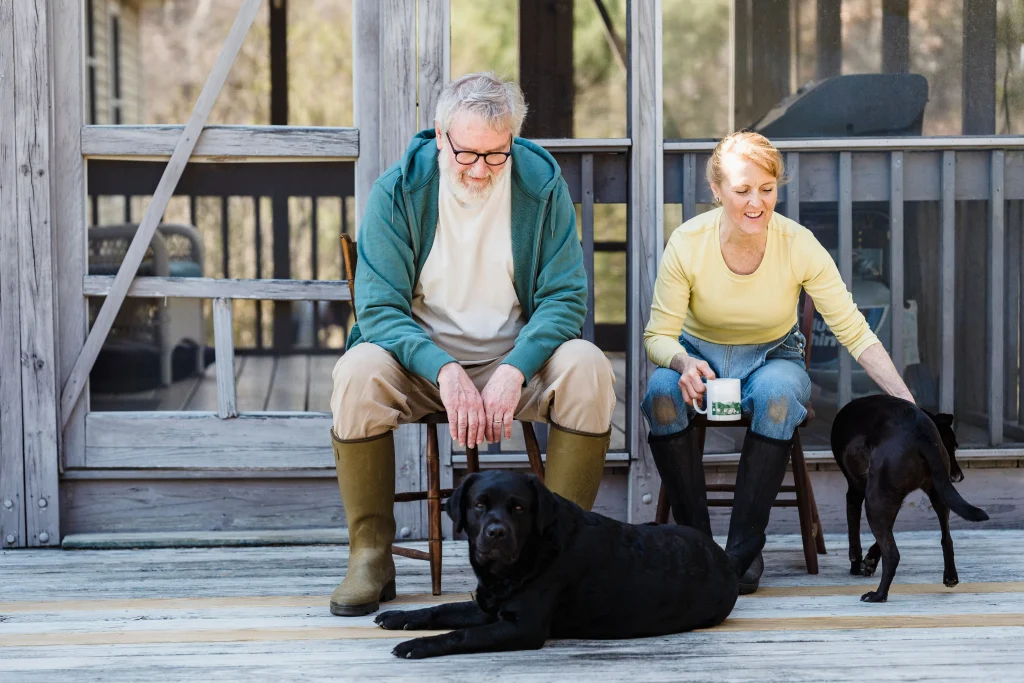 Couple spending quiet time outdoors with their dogs.